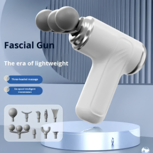 Fascial gun with attachments on a stand against a blue background
